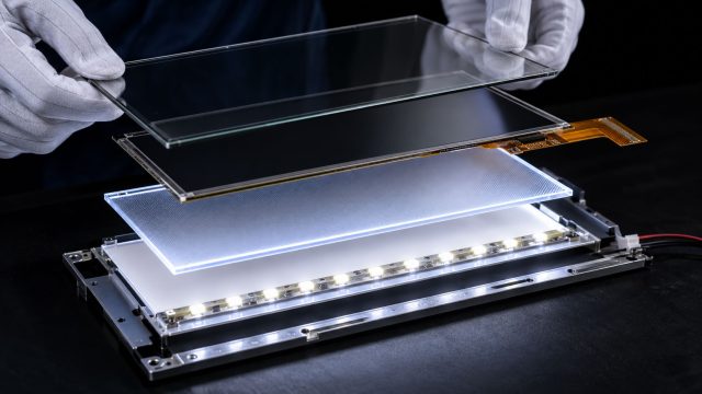 Disassembled TFT LCD module showing the LED backlight, light guide plate and LCD panel that set its power consumption